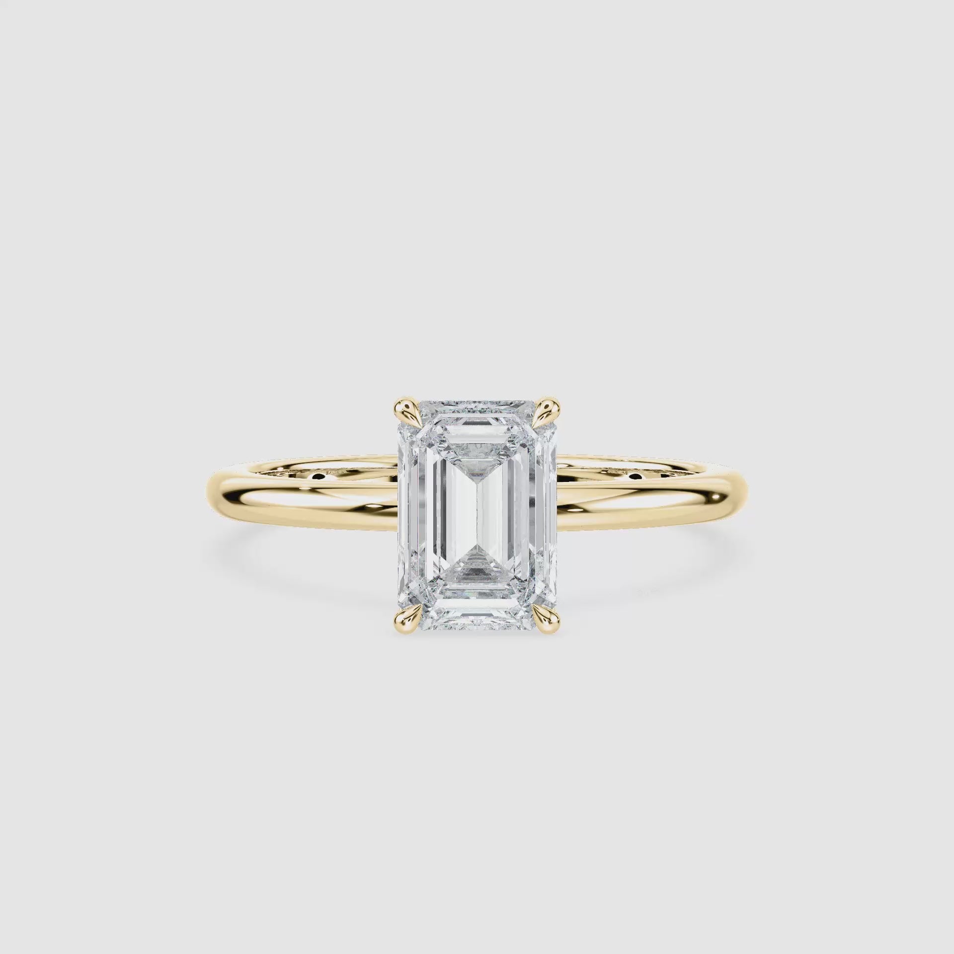 Video laden: Clara Solitaire Verlobungsring – Smaragdschliff – Gelbgold – Video